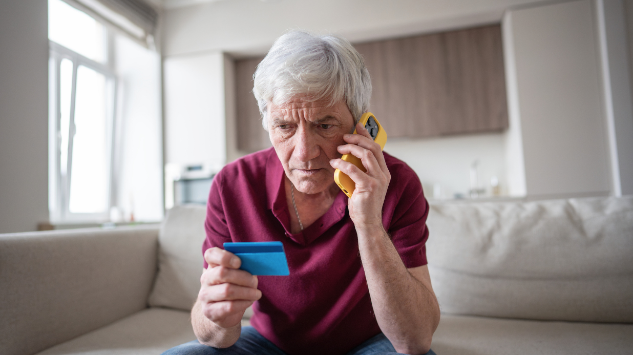 Blog Covers (57) Senior man on the phone while reading off credit card