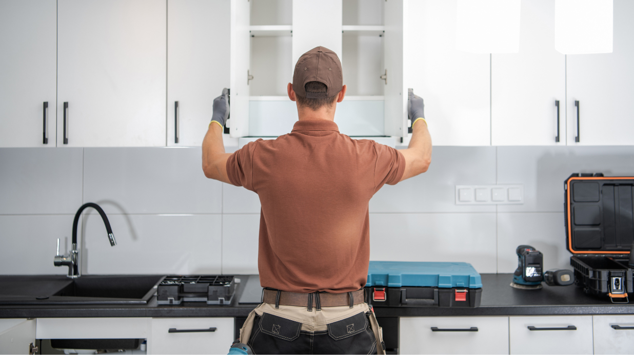 Contractor renovating kitchen cabinets
