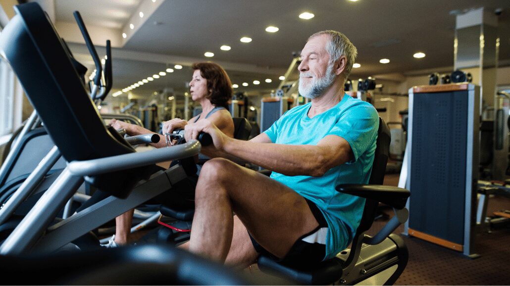 Blog Covers – 2024-09-24T115858.760 Senior couple at the gym riding recumbent bikes