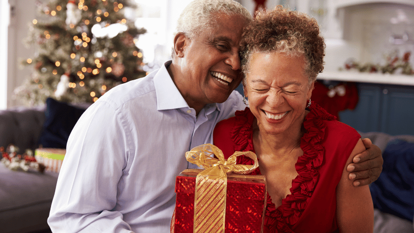 Senior man giving his wife a Christmas present