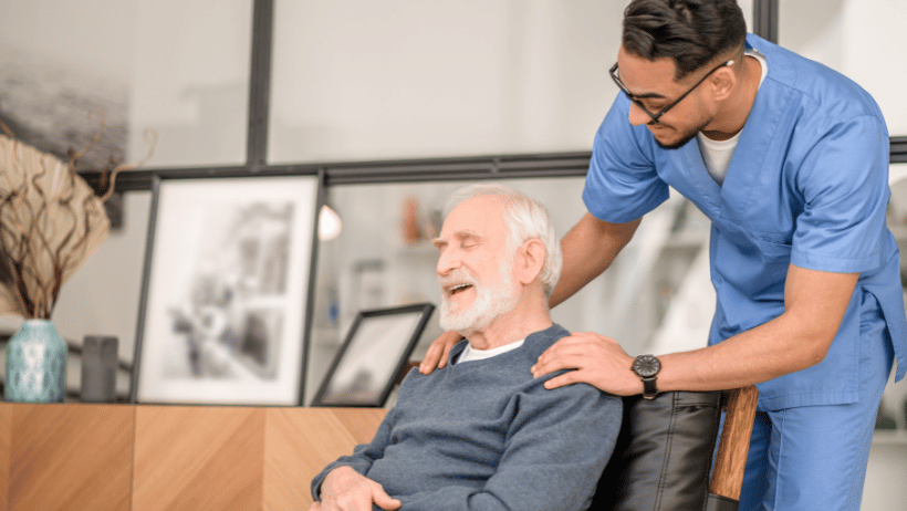 Senior man laughing with a male caregiver