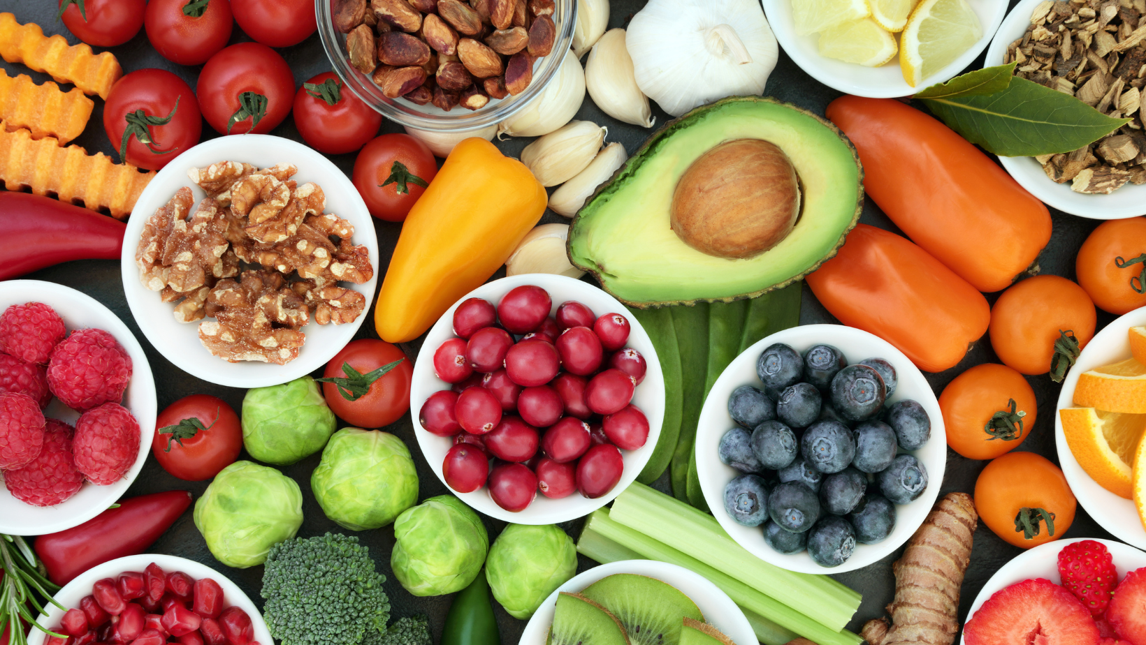 Blog20Covers20-202023-03-15T154908.898 Healthy foods on a table, including avocado, blueberries, nuts, and broccoli