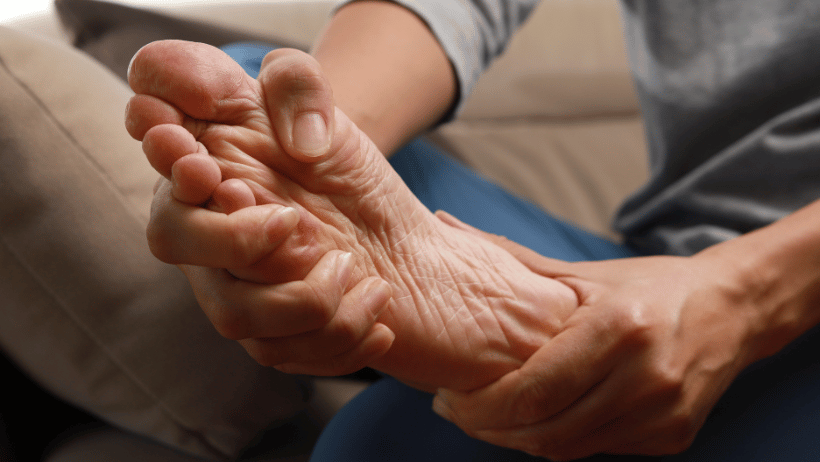 Senior woman rubbing her feet