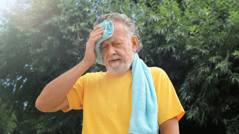 Blog20Covers20-202023-07-07T130733.663 Senior man outside in the heat, holding a towel to his forehead