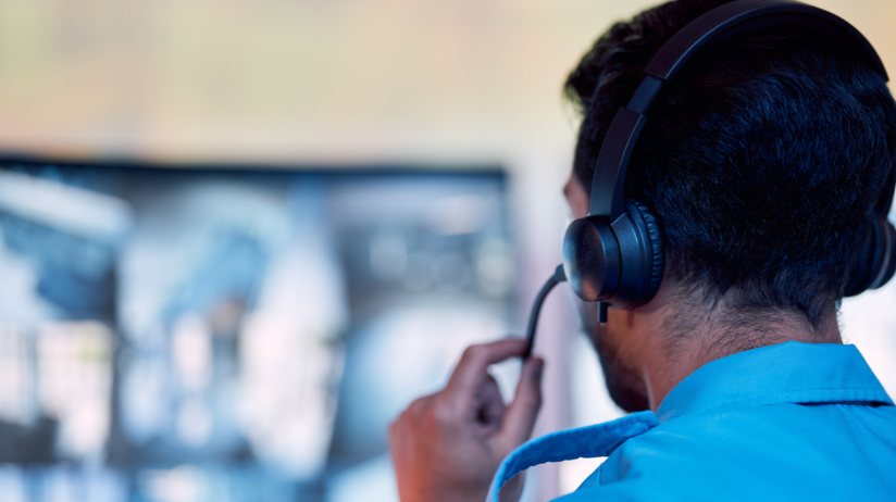 Blog20Covers20-202023-10-10T124634.324 Man with a headset on looking at a computer screen