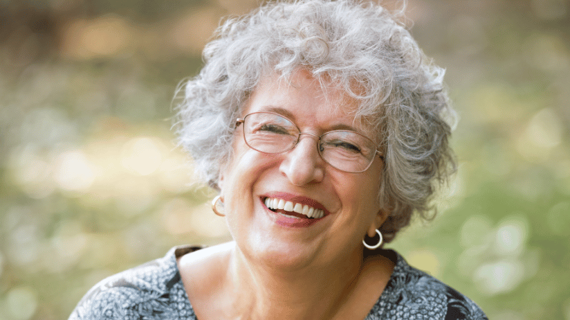 Smiling elderly woman outside