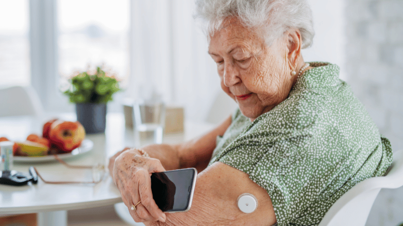 Senior woman checking her diabetes monitor