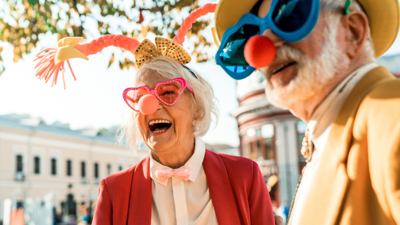 Senior couple dressed up with costume glasses and a clown nose