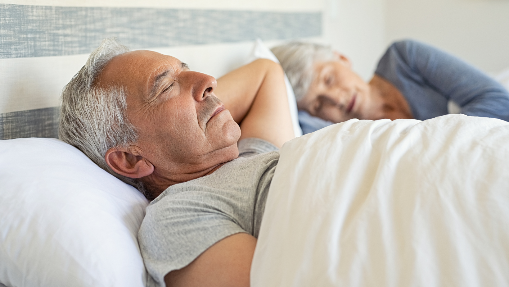 Senior couple sleeping in bed