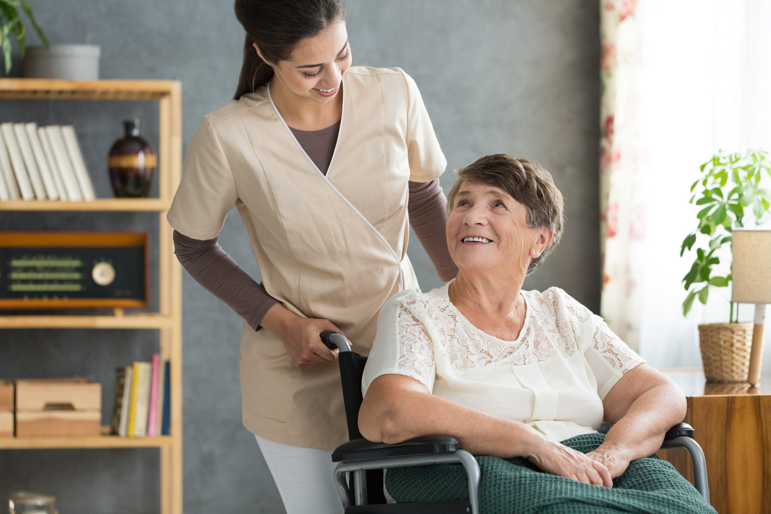 Concerned caregiver checking up on her elder patient