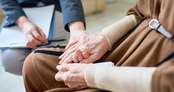 Senior woman holding her daughter's hand
