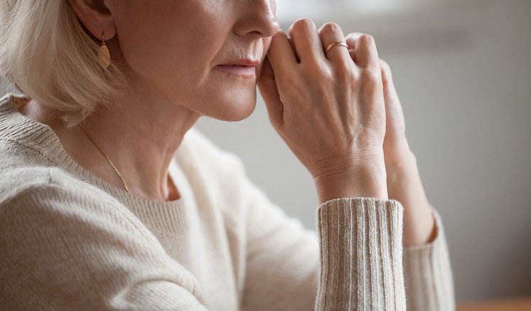Close up view of thoughtful mature woman worried about problems