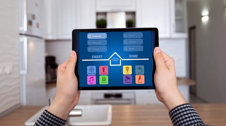 Male holding a tablet with a smart home app