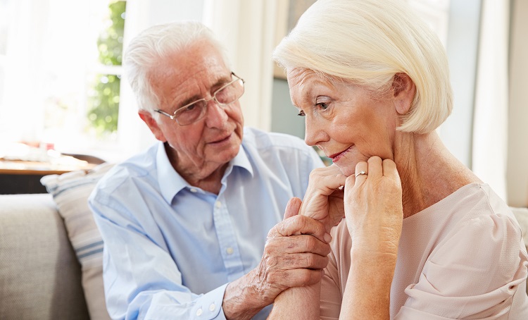 Senior Man Comforting Woman With Depression At Home