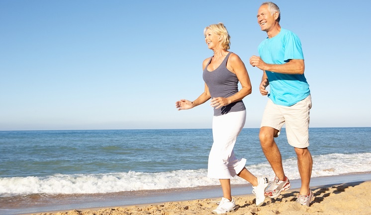 Senior-Couple-In-Fitness-Clothing-LR Senior couple runing along the beach