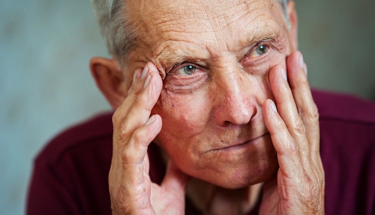 Senior20with20hands20on20his20face20while20staring20into20space20LR Senior with his hands on his face