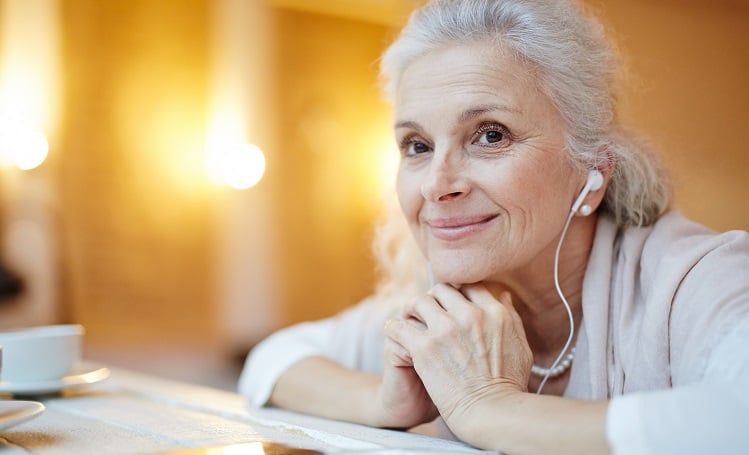 Senior20woman20listening20to20music20with20ear20buds20LR Senior woman smiling with headphones in