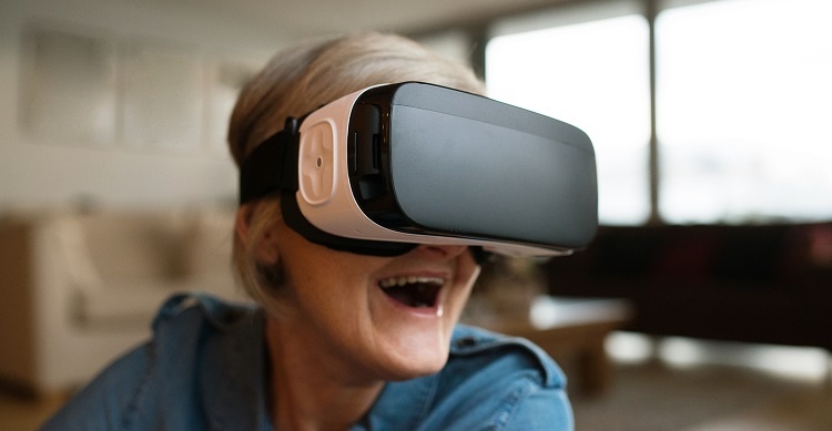 Senior woman wearing virtual reality goggles