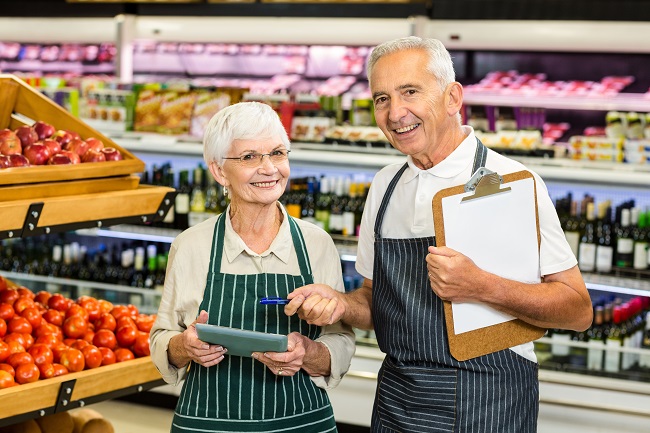 Senior colleagues with clipboard working