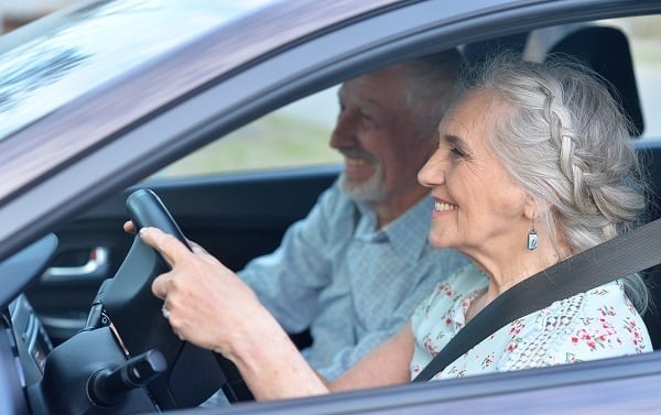Senior couple driving in a car