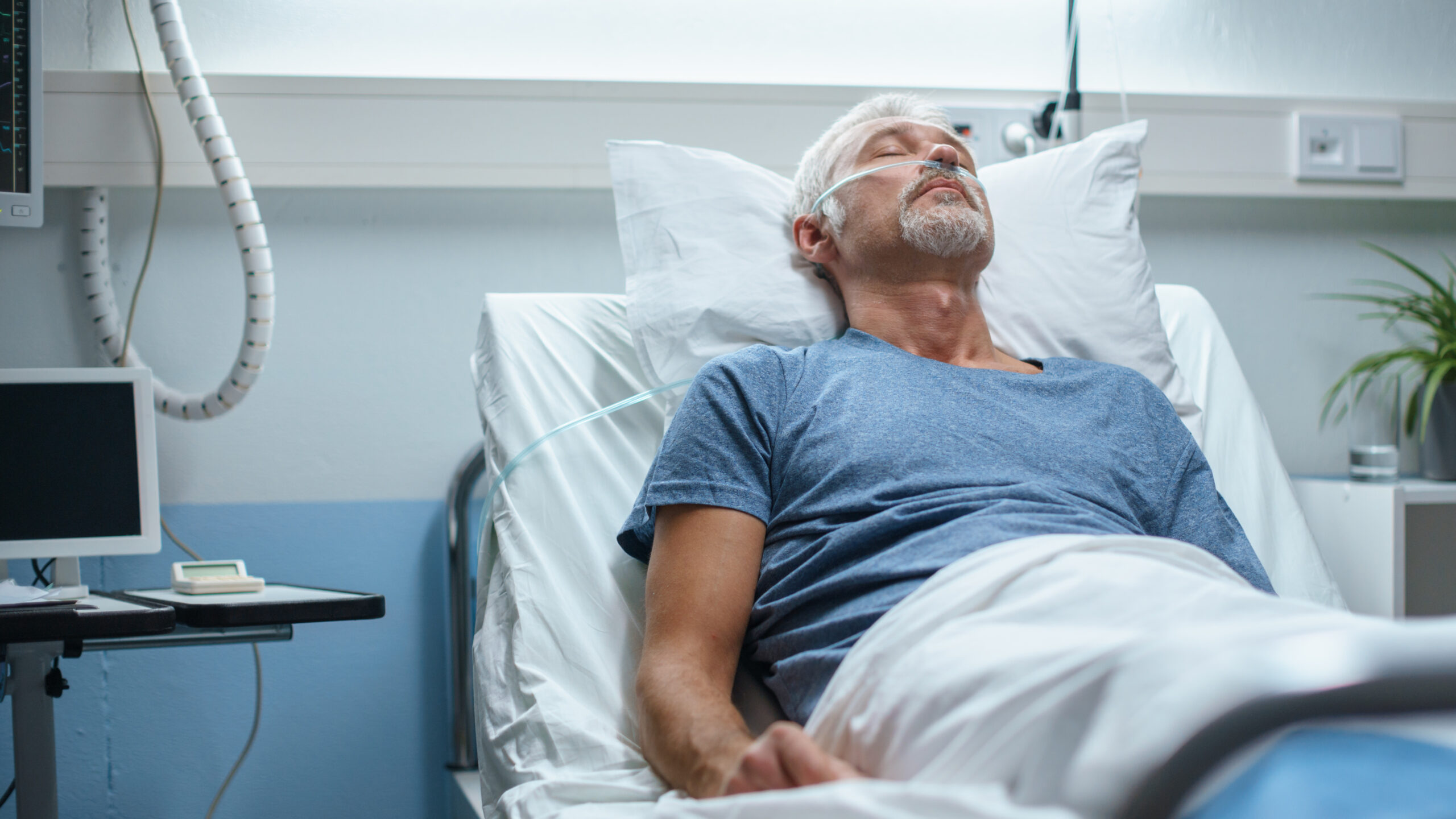 Senior man lying in a hospital bed