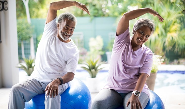seniors_working_out_couple-LR African American couple doing yoga