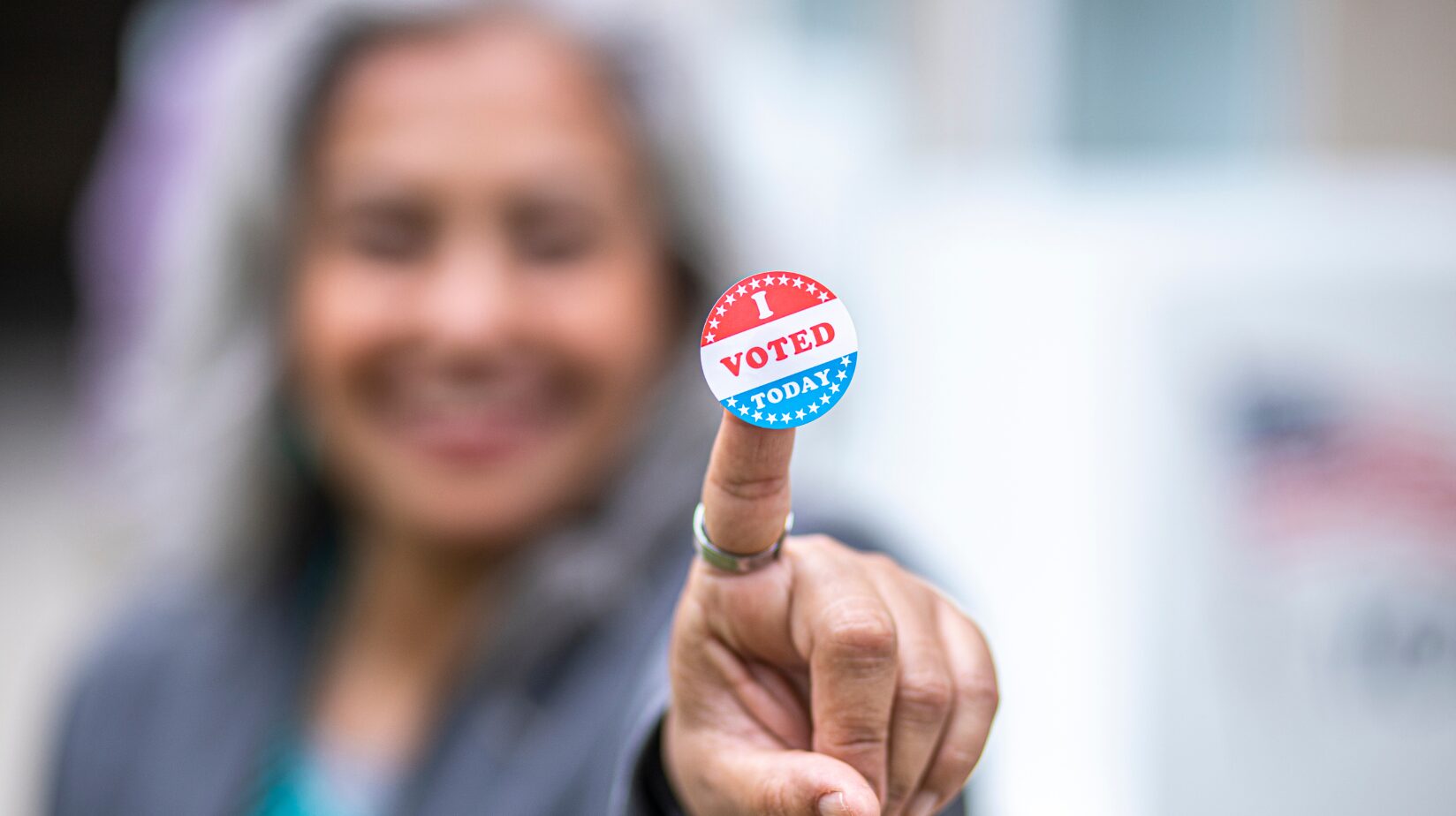 Blog Covers – 2024-09-11T150408.033 Senior woman holding up an "I voted" sticker