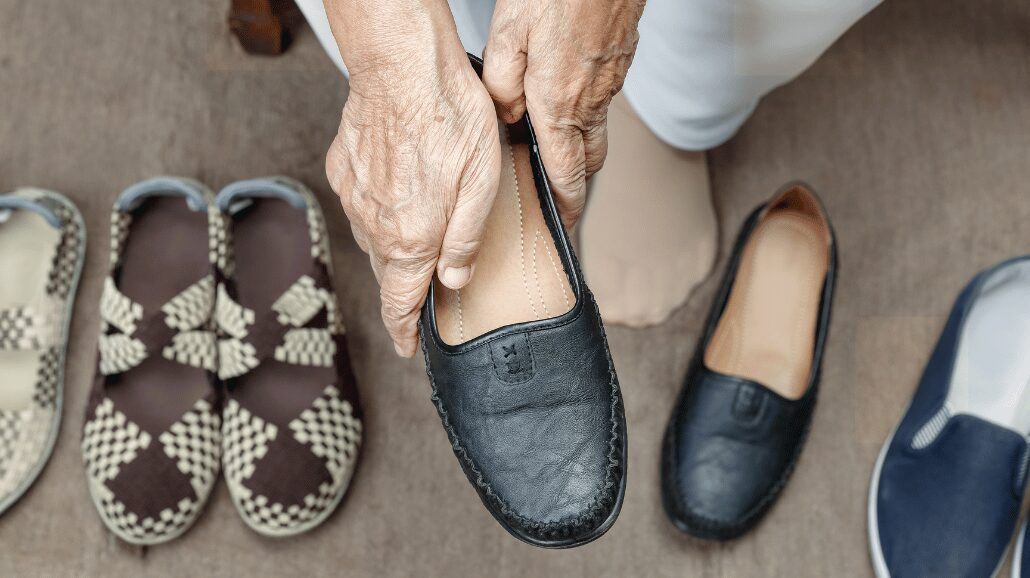 Senior woman selecting a pair of shoes
