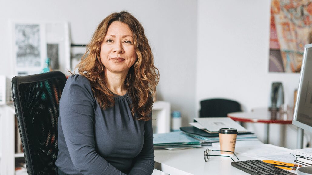 Blog Covers – 2024-10-02T153336.448 Confident middle-aged employee sitting at a desk