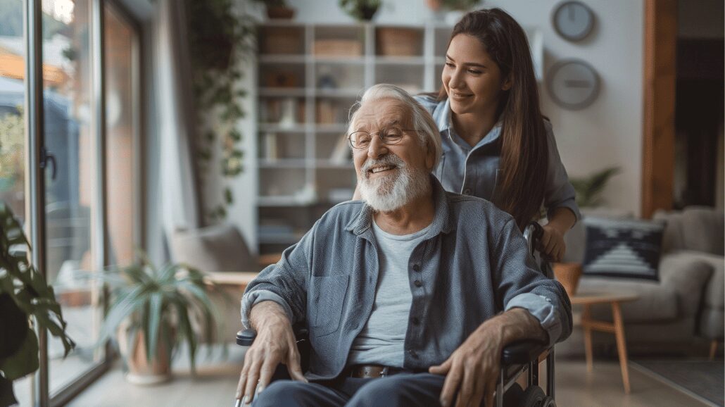 Family caregiver pushing an elderly man in a wheelchair around his home