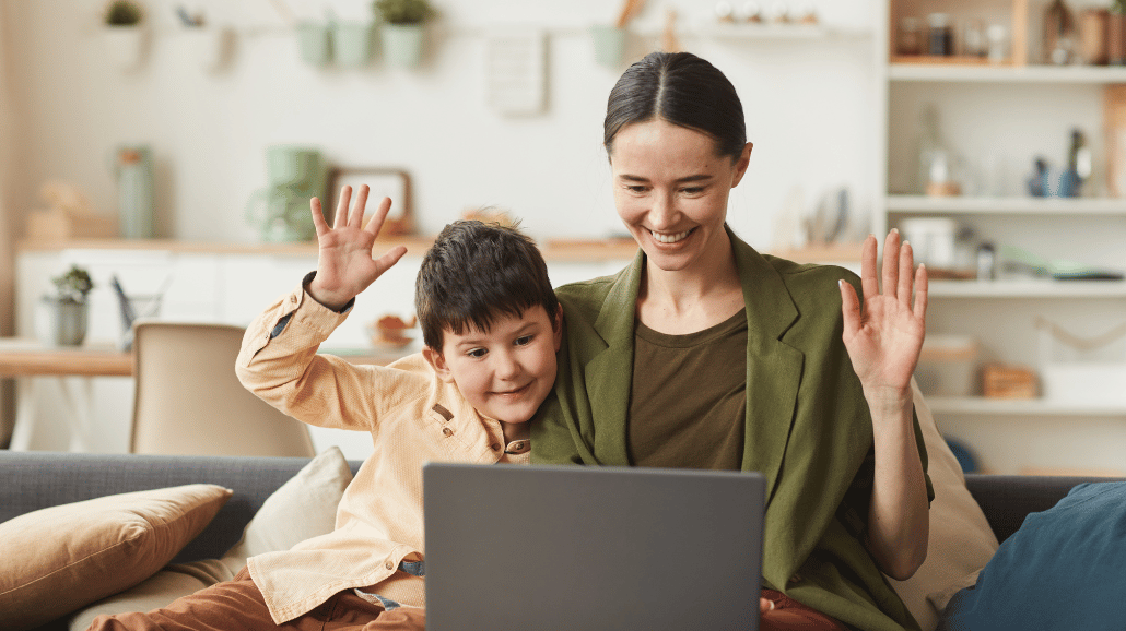 Woman and her young son waving on a video call