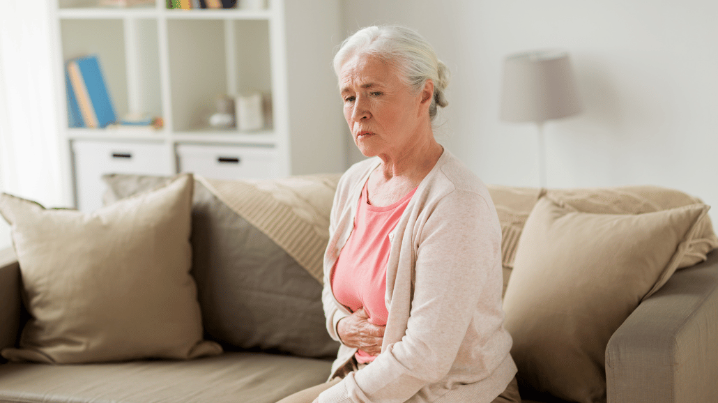 Senior woman holding her stomach