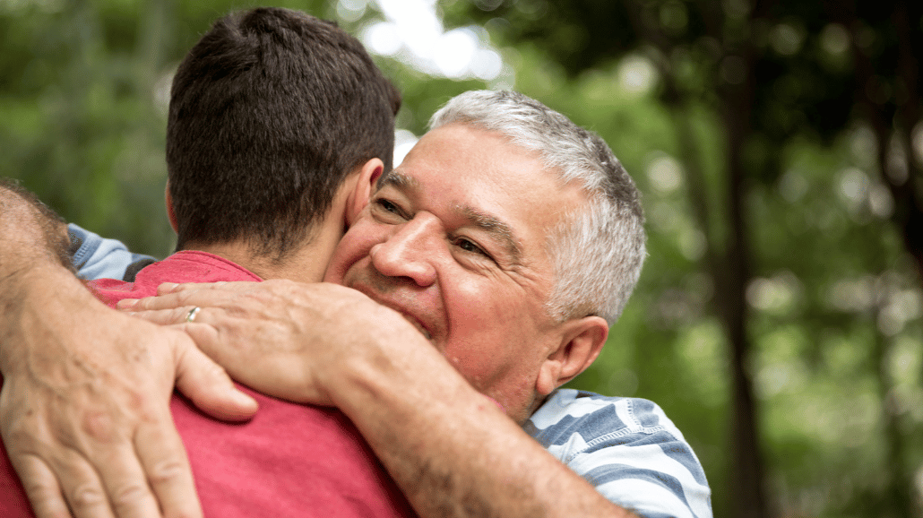 Senior man hugging his son