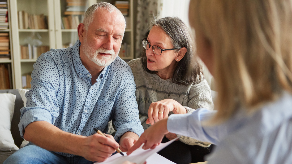 Senior couple reviewing power of attorney with a laywer