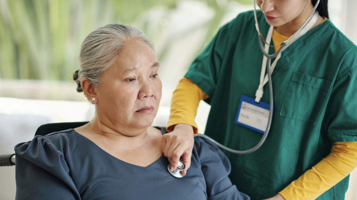 Senior woman getting checked by a nurse after a fall