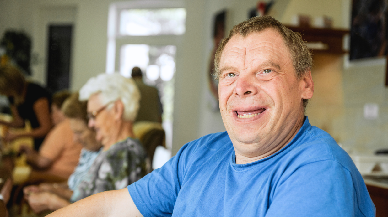 Senior man with Down syndrome doing activities at a senior center
