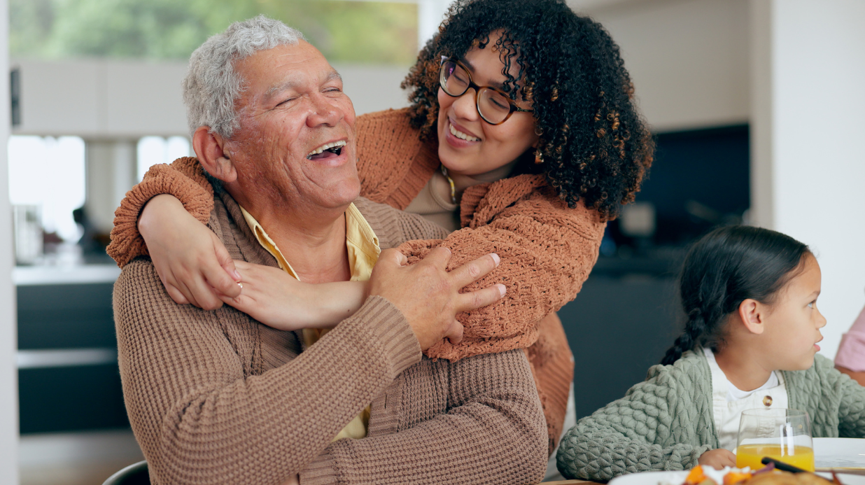Family caregiver hugging her dad