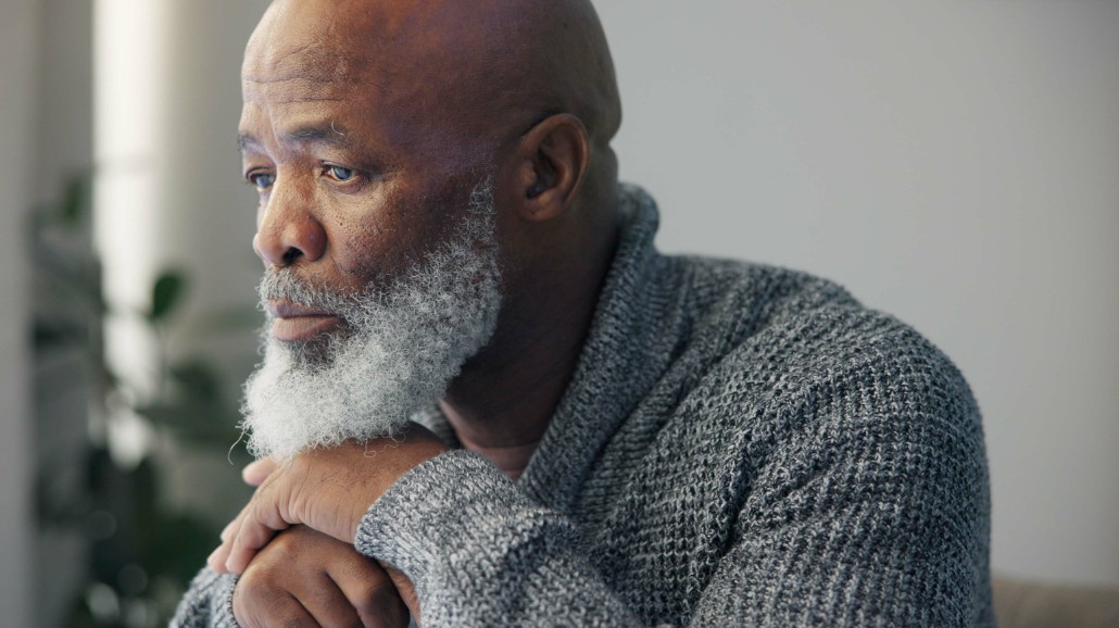Blog Covers (65) elderly black man staring out the widow in grief