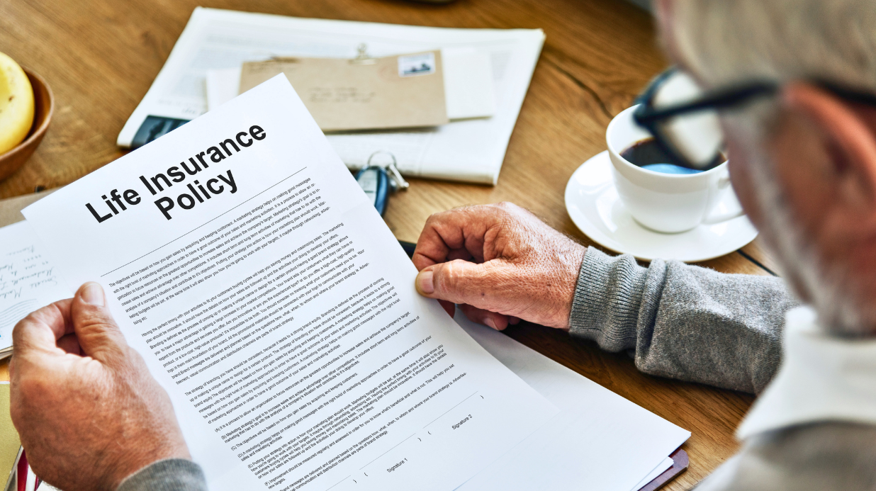 Senior man holding life insurance policy