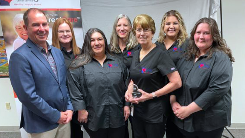 Jeff Salter and Caring Galesburg team presenting Caregiver of the Year 2022 Deb Smith