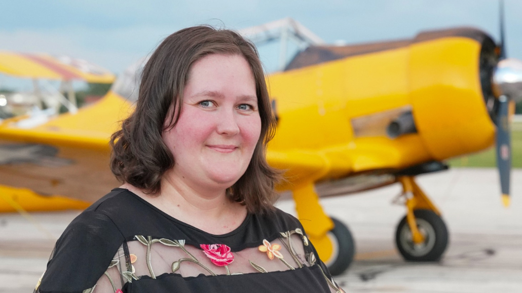 Katy Packingham with a plane in the background