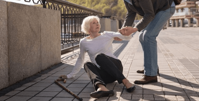 Elderly woman fallen down outside