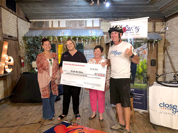 6109c47816599.image_ Jeff Salter receives a donation for Close the Gap in Senior Care