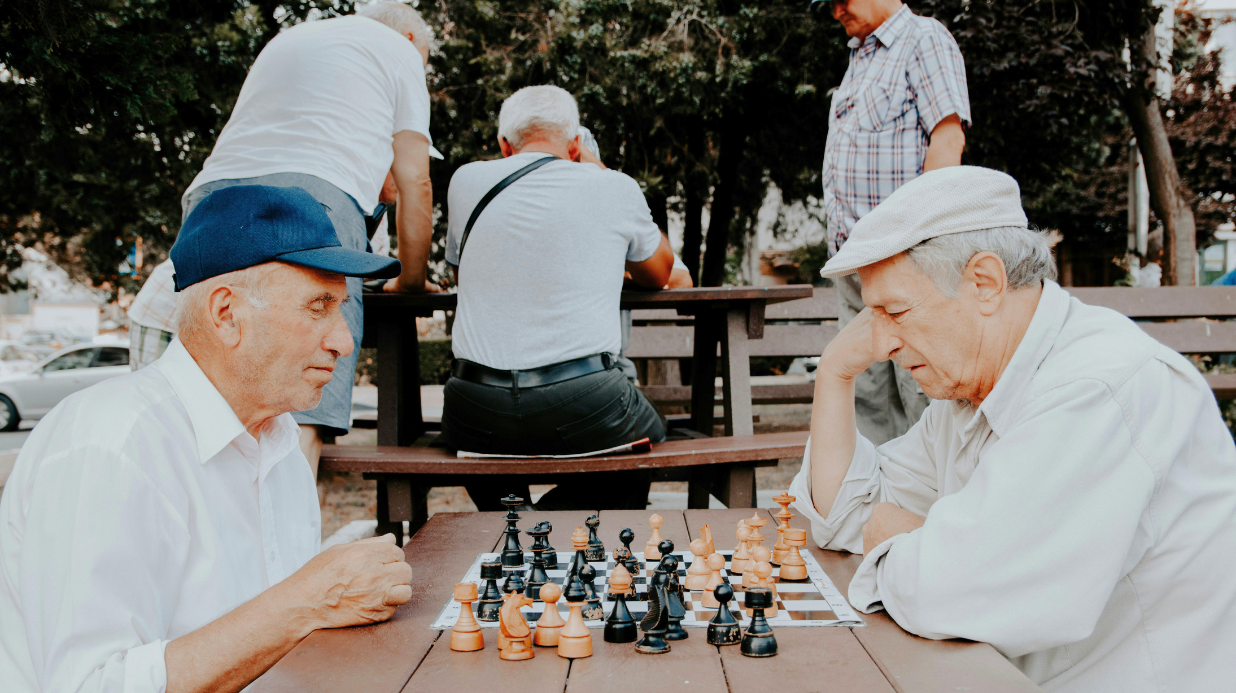 Two old men playing chess in a park