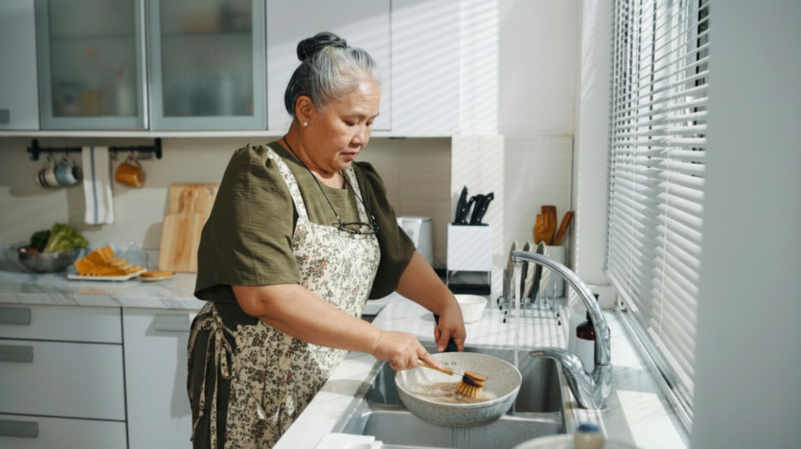 Senior woman washing dishes