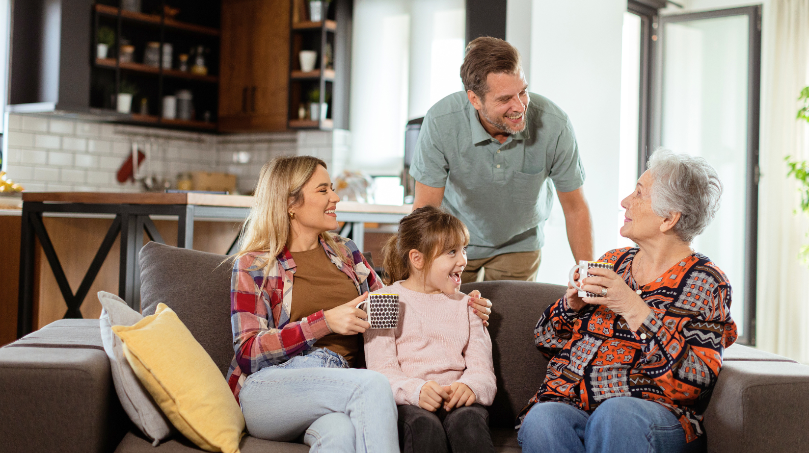 Multi-generational family sitting on the couch talking together